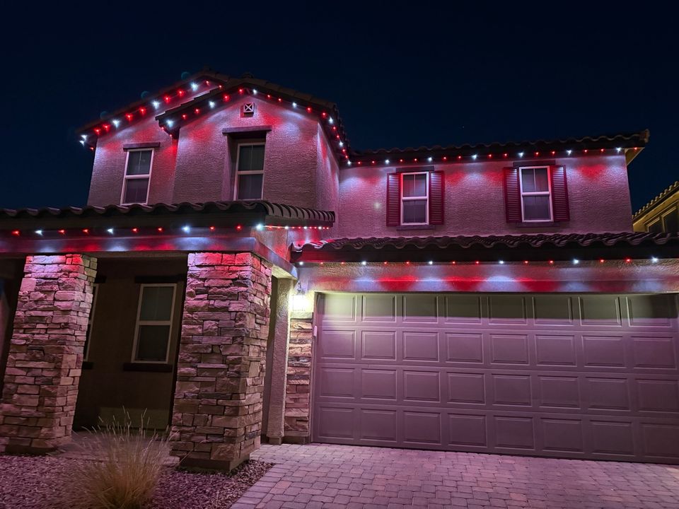 The same Las Vegas home lit in red and white by Encompass Lighting