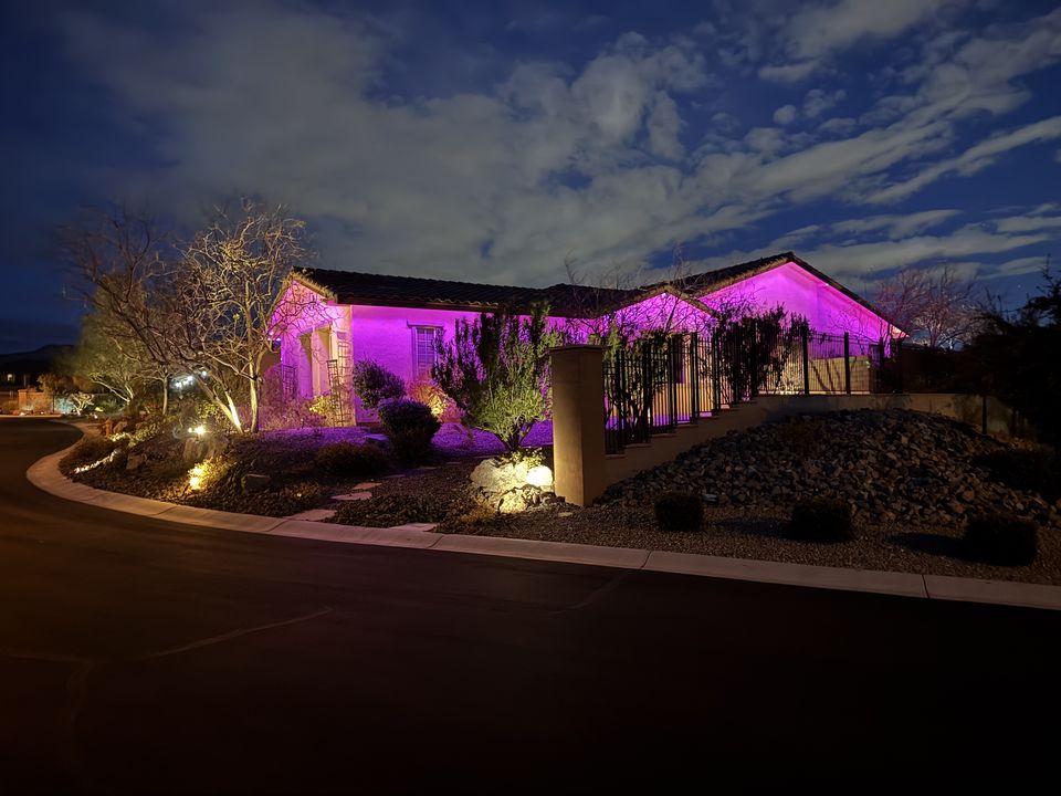 Purple permanent lighting installed by Encompass Lighting on a desert home
